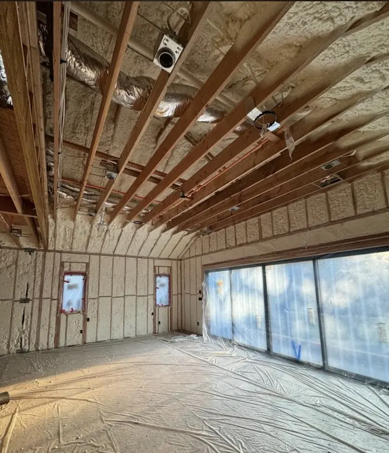 Interior walls and ceiling insulated with spray foam during new construction in Astoria